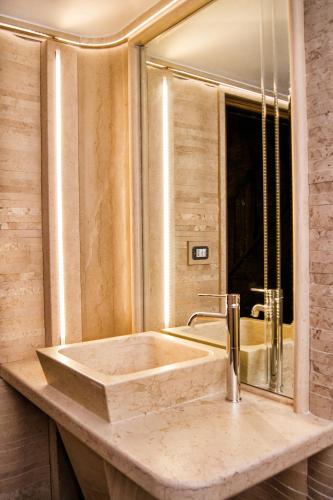 a bathroom with a sink and a mirror at B&B Casa Dilillo in Foggia