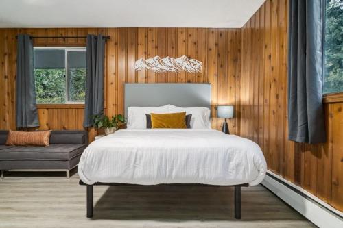 a bedroom with a large bed and a couch at Gateway Suites Near Canmore and Banff in Canmore