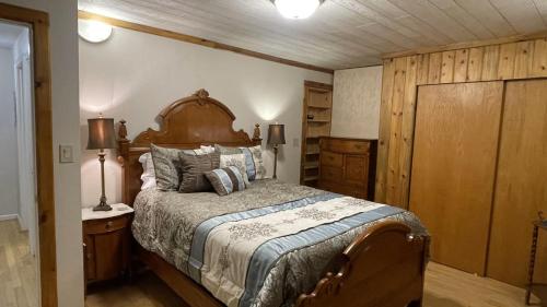 a bedroom with a large bed with a wooden headboard at Frontier Lux 2 Bedroom in Hamilton Acres