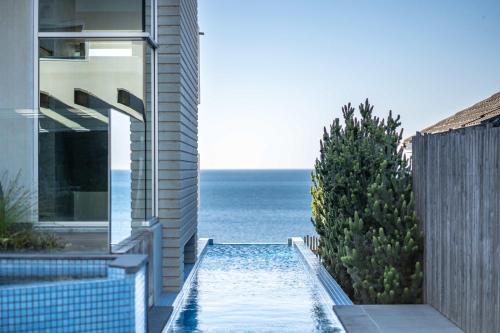 a view of the ocean from a house with a swimming pool at One Eighty Marino in Marino