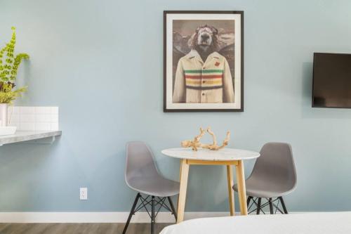 a dining room with a table and a picture on the wall at Gateway Suites Perfect Escape to explore Banff in Canmore