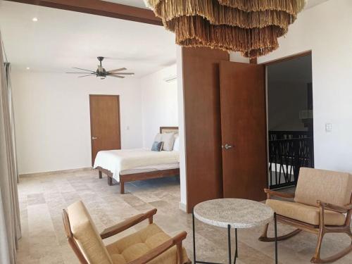 a bedroom with a bed and a table and chairs at Villa de lujo frente al mar de Progreso in Progreso