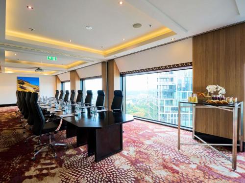 a conference room with a long table and chairs at Sofitel Melbourne On Collins in Melbourne