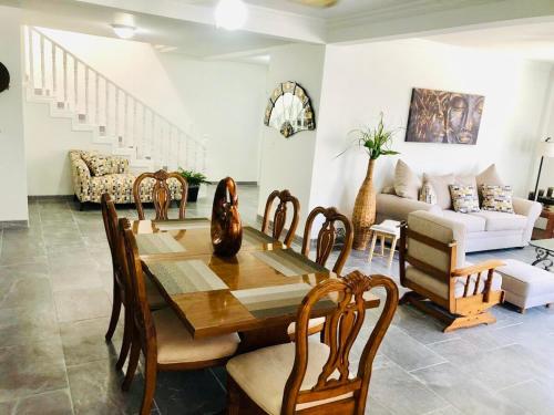 a dining room with a wooden table and chairs at Casa Encanto Ensenada Three Bed Two Bath in Ensenada