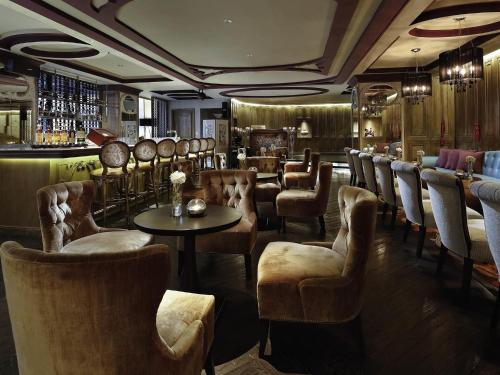 a bar with a bunch of chairs and a table at Sofitel Saigon Plaza in Ho Chi Minh City