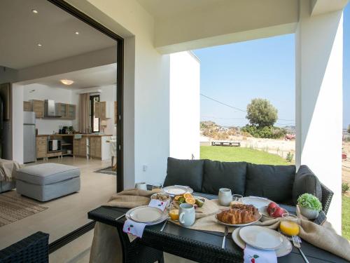 a living room with a table with food on it at Secluded Villa with Panoramic Sea View in Rhodes Town