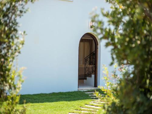 an entrance to a blue building with a door and stairs at Secluded Villa with Panoramic Sea View in Rhodes Town