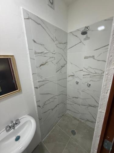 a bathroom with a sink and a shower at La Vecindad in Querétaro