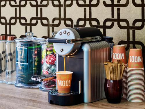 a coffee maker sitting on a table with cups at Mercure Paris Gare De Lyon TGV in Paris
