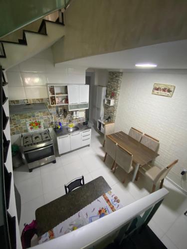 a view of a kitchen with a table and chairs at Casa Aconchego COP 30 em Belém in Belém