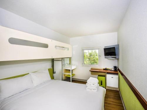 a small room with a bed and a desk at ibis Budget - St Peters in Sydney