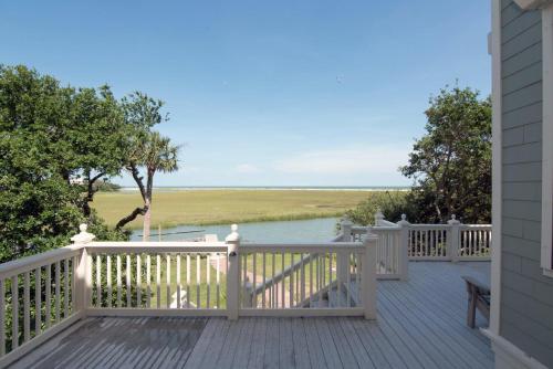 a wooden deck with a view of a river at Moonrise Point in Edisto Island