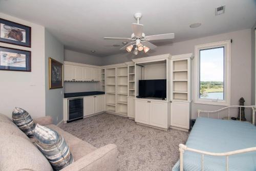 a living room with a couch and a ceiling fan at Moonrise Point in Edisto Island