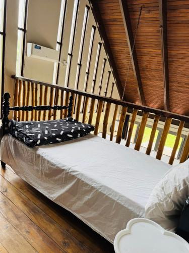 a bed in a room with a wooden floor at MIRZ Accomodation Villa 2 in Pacific Harbour