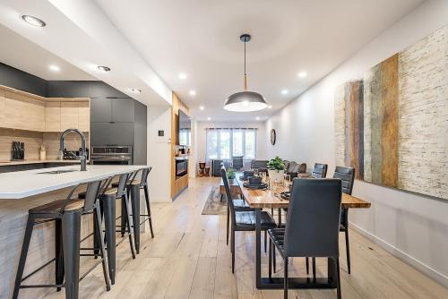 a kitchen and dining room with a long table and chairs at FREE PARKING PRIME LOCATION NEW MODERN CONDO in Brossard