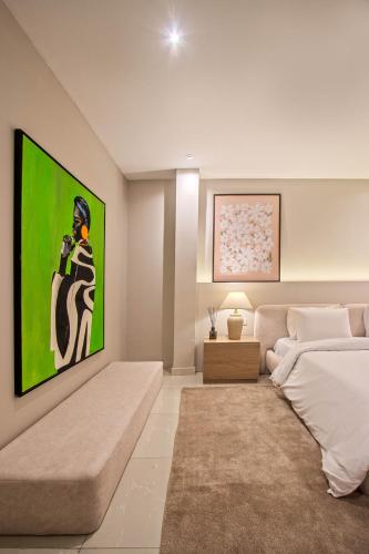 a living room with a large painting on the wall at The Metropolis Lekki in Lekki