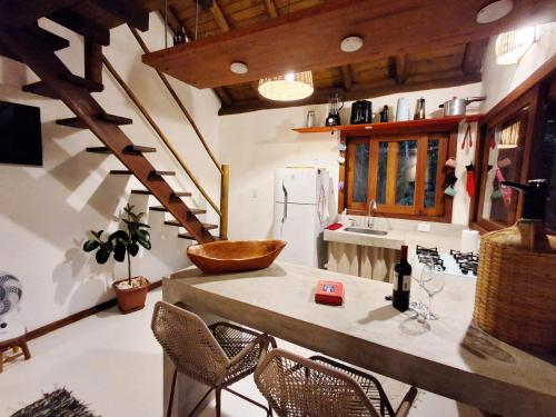 a kitchen with a table with a bowl on it at Casinha Mandala 2 - Taipu de Fora in Taipu