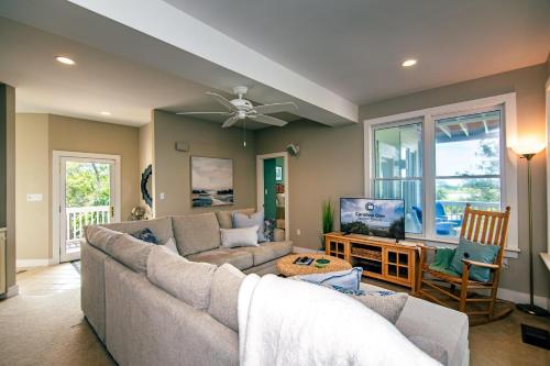 a living room with a couch and a tv at Tequila Sunset in Edisto Island