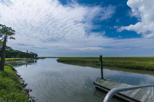 a boat traveling down a river in a field at Tequila Sunset in Edisto Island