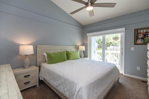 a bedroom with a bed with a ceiling fan and a window at 478 Egrets Pointe in Edisto Island