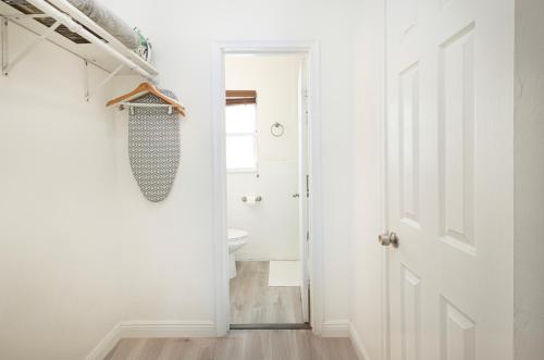 a bathroom with a white door and a sink at The Oasis in Miami