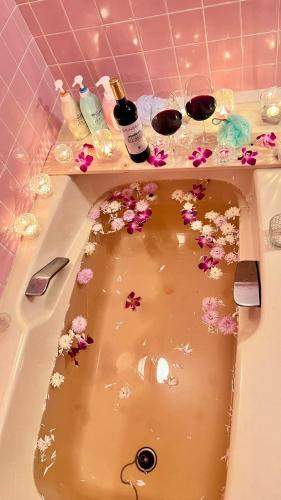 a bath tub filled with flowers and cosmetics at Grace House Hill Paradise Atami in Atami