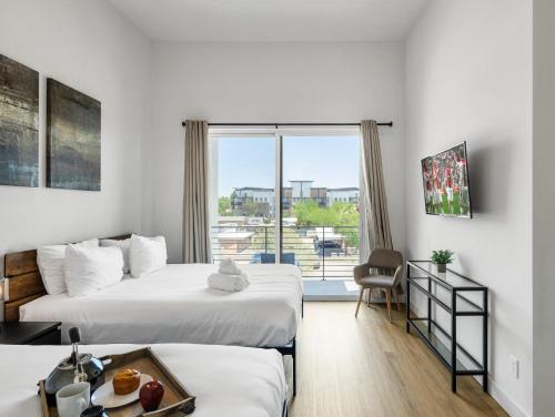a hotel room with two beds and a window at The Social - Jacuzzi - Heart of Old Town in Scottsdale