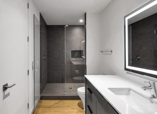 a bathroom with a toilet and a sink and a shower at The Social - Jacuzzi - Heart of Old Town in Scottsdale