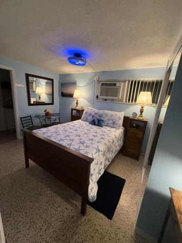 a bedroom with a bed and a blue light at Studio Yunet in Bradenton