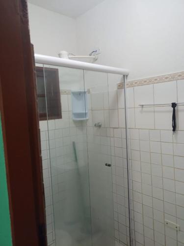 a bathroom with a shower with a glass door at Pousada costa in Paraty