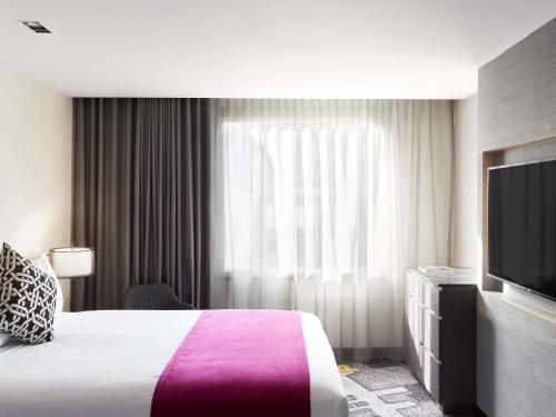 Ένα ή περισσότερα κρεβάτια σε δωμάτιο στο Pullman Melbourne City Centre