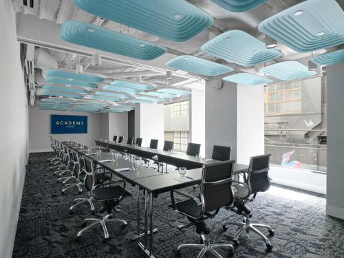 a long conference room with a long table and chairs at Mercure Welcome Melbourne in Melbourne