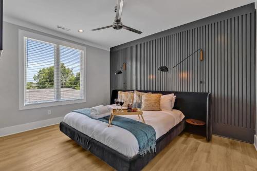 a bedroom with a bed with a table on it at Ensemble-4 Unit Combo-8 mins to Broadway in Nashville