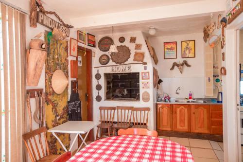 a kitchen and dining room with a table and a table and chairs at Rio Uruguai Pousada in Uruguaiana