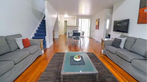 a living room with a couch and a table at Plover Executive Deluxe Villa 25 in Cams Wharf