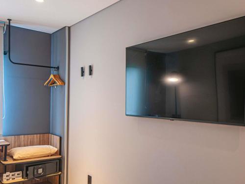 a large flat screen tv hanging on a wall at Ibis Monterrey Aeropuerto in Monterrey