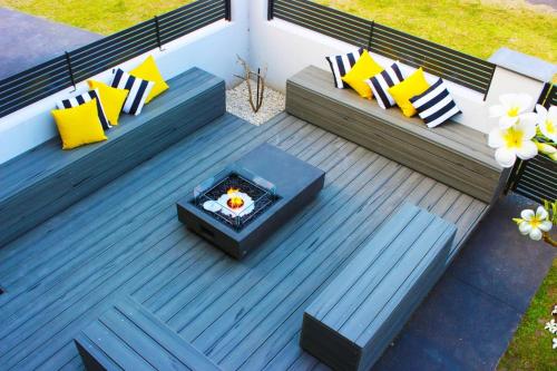 an overhead view of a deck with a fire pit at Skyes Beach House-Views, Spas, Sauna, Arcade Games in Surf Beach
