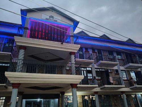 a building with a purple and blue sign on it at Mango Plaza in Homa Bay