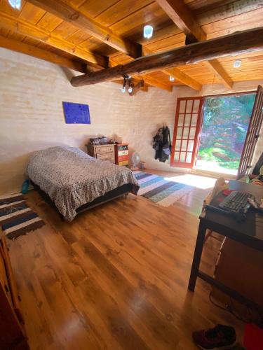 a bedroom with a bed and a desk in a room at Casa Principal in Itapeva