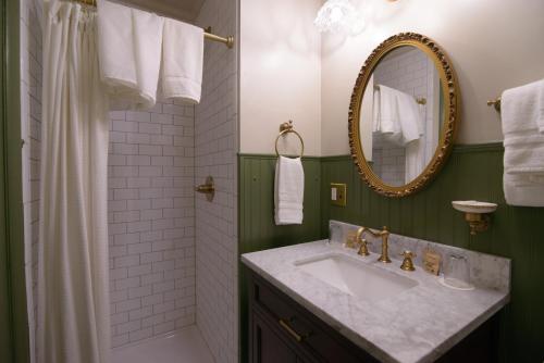a bathroom with a sink and a mirror at Moore House Inn & Cabins in Marlinton