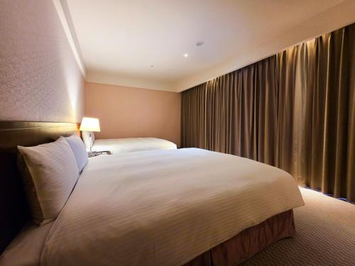 Cama o camas de una habitación en 雀客旅館台中來來