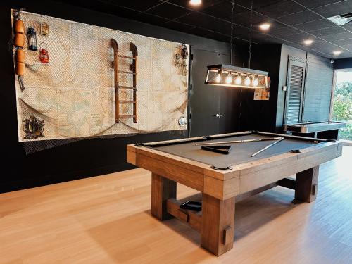 a ping pong table in a room with a painting at New! 4-Story Villa, Private Rooftop, Pool and Marina in Key Largo in Key Largo