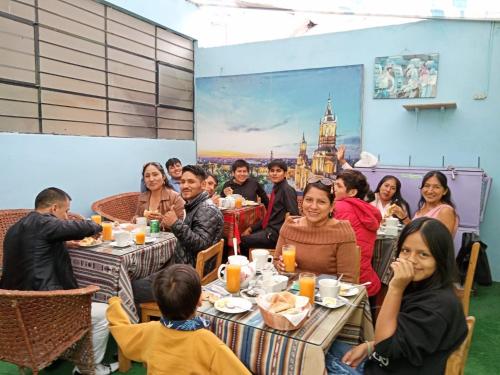 un grupo de personas sentadas en mesas en un restaurante en Hostel Fuentes, en Arequipa