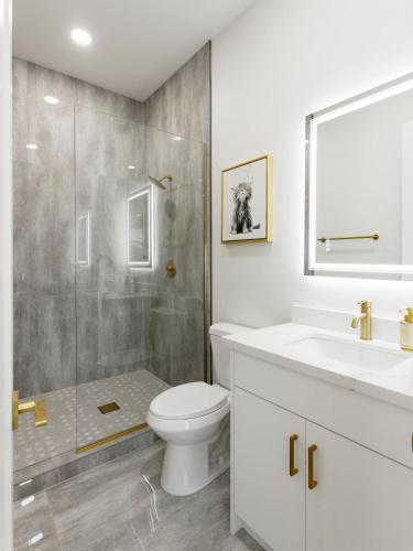 a white bathroom with a toilet and a shower at LUXE - Nouveau - Sparkling Pool - Walk to Old Town in Scottsdale