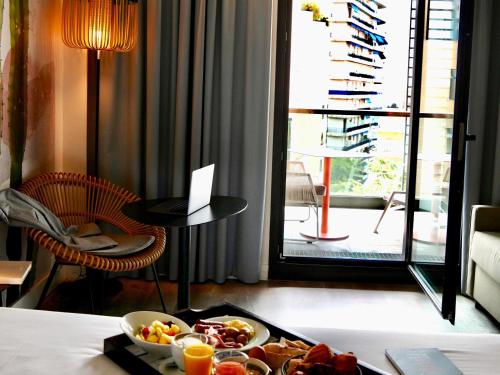 a tray of food on a table in a hotel room at Novotel Monte-Carlo in Monte Carlo