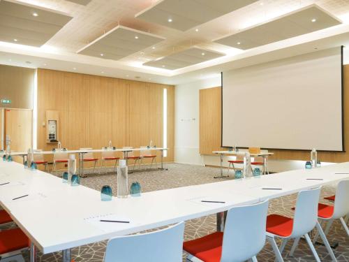 a conference room with tables and a whiteboard at Novotel Monte-Carlo in Monte Carlo