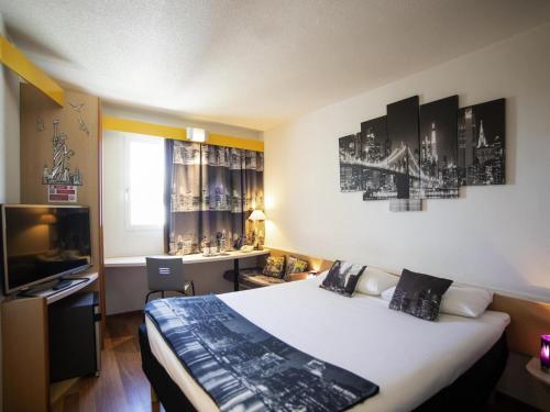 Cama o camas de una habitación en ibis Fribourg