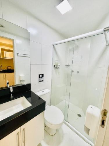 a bathroom with a toilet and a glass shower at Wise SP Expo Center e Anhembi in São Paulo