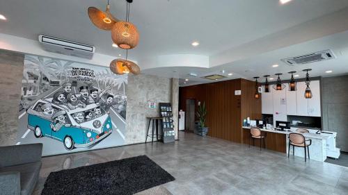 a living room with a painting of a bus at Greenlast Hotel in Kuantan