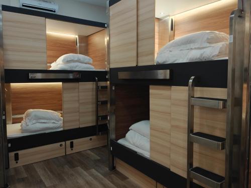 a room with four bunk beds in it at I Street Capsule Hostel in Washington, D.C.
